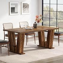 a dining room table with chairs and a vase on top of it in front of a large window