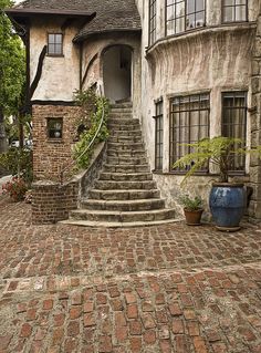 an old house with stone steps leading up to it