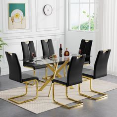 a glass dining table with black chairs and gold legs