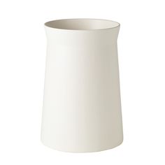 a white vase sitting on top of a table