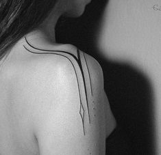 the back of a woman's shoulder with lines on her left arm and chest