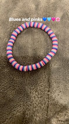 a pink and blue striped bracelet on a gray blanket with the words, blues and pinks