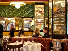 two people sitting at a table in a restaurant