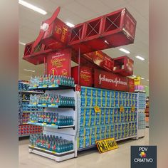 a large display in a grocery store filled with water and other items for sale on the shelves