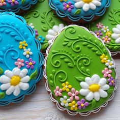 several decorated cookies sitting on top of a table