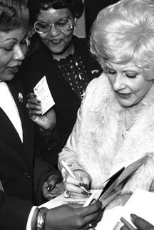 an old photo of two women signing autographs for someone to sign on their wedding day