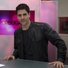 a man standing in front of a desk