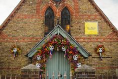 an old church with skulls and flowers on the front