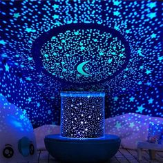 a room filled with lots of stars and moon lights on the ceiling next to a round table