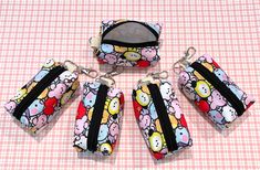 hello kitty purses and keychains on a pink checkered tablecloth