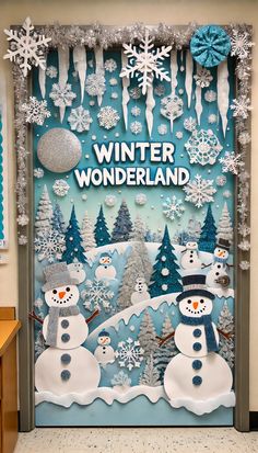 a door decorated with snowmen, trees and decorations for the winter wonderland theme at school