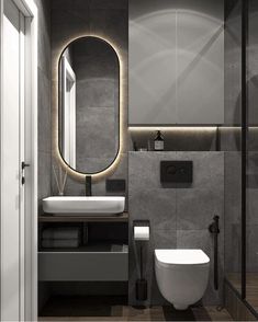 a bathroom with a toilet, sink and mirror in it's corner area next to a shower stall