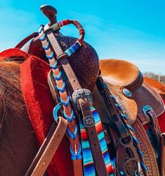 a saddle with several different colored leathers on it