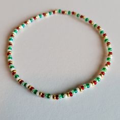 This festive Nutcracker Stretch Bracelet will be a standout addition to your holiday wardrobe! This perfectly-themed piece of jewelry features green, red, white, and gold seed beads to give it that extra something special. C'mon, crack a smile! Christmas Seed Bead Jewelry, Green Beaded Bracelet For Holiday, Handmade Green Beaded Bracelets For Holidays, Green Beaded Bracelets For Festive Occasions, Festive Green Beaded Bracelets With Colorful Beads, Green Stretch Bracelet With Colorful Beads For Party, Multicolor Beaded Bracelets For Holiday, Festive Green Beaded Bracelets, Holiday Multicolor Round Beads Bracelets