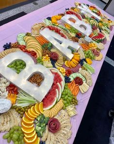 a table topped with lots of different types of fruits and veggies on it