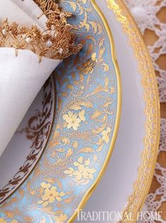 gold and blue plates with napkins on them