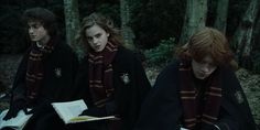 harry potter and hermione's school uniform in the woods with their book