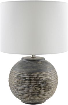 a table lamp with a white shade on it's base and a silver finish