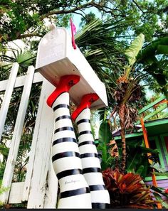 a white fence with black and white striped stockings on it