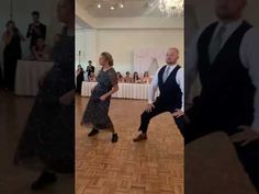 two people are dancing on the dance floor