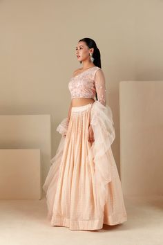 Peach One Shoulder Lehenga Set, featuring zardosi hand-embroidered crop top and pleated skirt tied with a drawstring. Complete with padding, organza ruffle dupatta, and self-embroidered color, this set exudes elegance. Peach Semi-stitched Lehenga With Traditional Drape, Festive Peach Unstitched Lehenga, Semi-stitched Peach Choli With Sheer Dupatta, Peach Semi-stitched Georgette Lehenga, Festive Semi-stitched Peach Lehenga, Ruffle Dupatta, Western Gown, Indo Western Gown, Organza Lehenga