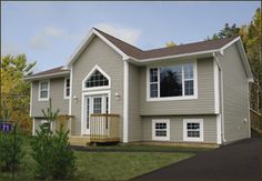 a two story gray house with white trim and windows on the second floor is shown