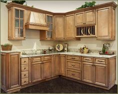 an image of a kitchen setting with wooden cabinets and granite counter tops on the floor