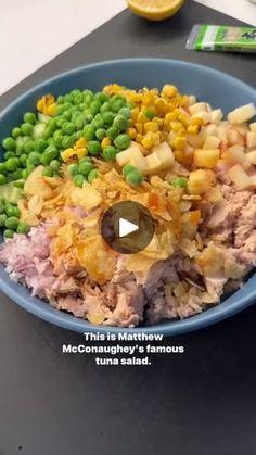 a blue bowl filled with food on top of a table