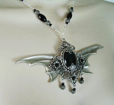 "This beautiful necklace has black pearl beads, sterling silver plated filigree beads, seed beads, sterling silver plated chain and a sterling silver plated pendant with sterling silver plated wings, sterling silver plated embellishments, rhinestone accents and black agate setting. 16\" long can be adjusted to 20\" long. Sterling silver plated lobster clasp."