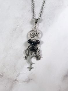 This beautiful chain necklace is the perfect way to express your affinity for Lilith. Charms: Snake Astrological Symbol Owl 3 garnet beads and one onyx bead also make up the pendant. Your choice of top charm: Pentacle, Chandelier, or Triple Moon Available in a variety of lengths. Secured with a lobster clasp. Chain is stainless steel. Charms are zinc alloy. All materials are lead and nickel free. Comes in a jewelry box so it's ready to be given as a gift. Have a idea for a custom order? I'd love Elegant Black Charm Necklace, Black Metal Pendant Charm Necklace, Symbolic Black Jewelry With Adjustable Chain, Spiritual Black Chain Necklaces, Black Spiritual Chain Necklace, Black Symbolic Jewelry With Adjustable Chain, Symbolic Black Necklace With Adjustable Chain, Symbolic Black Jewelry With Charms, Spiritual Black Chain Necklace