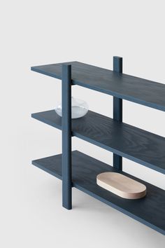 the shelf is made out of dark blue wood