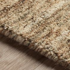 a close up view of a rug with brown and tan colors on the carpeting