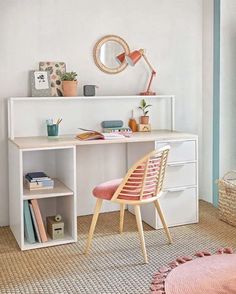 a room with a desk, chair and bookshelf next to a window in it