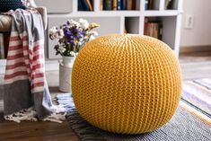 a large yellow ball sitting on top of a wooden floor