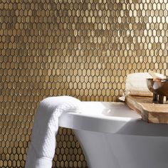 a white bath tub sitting next to a wooden cutting board