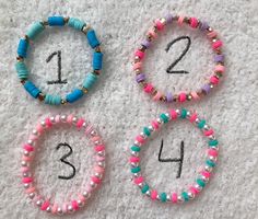 three bracelets with numbers on them sitting on the floor next to each other,