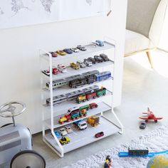 toy cars and trucks are on display in the children's room