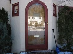 the front door of a house with snow on the ground