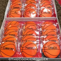 orange basketballs with names on them are in a display case at the cookiemongery