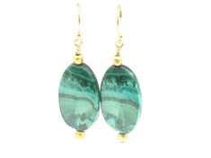 "Your friends will be green with envy when you wear this stunning matched pair of malachite earrings.  The earring is 1 1/4\" long with its' drop length 1 3/4\".  Each malachite oval is bracketed on top and bottom with a cubed gold bead.  They are suspended from 14k gold filled ear wires and are one of a kind. Please contact me BEFORE PURCHASE for the correct shipping costs outside of the Continental USA.  Thank you. Click on the link below to visit my shop: https://www.etsy.com/shop/cherylpeter Elegant Green Agate Earrings, Elegant Green Chrysocolla Jewelry, Handmade Round Emerald Earrings, Spiritual Green Gemstone Earrings, Green Onyx Drop Earrings, Green Spiritual Earrings With Natural Stones, Spiritual Green Earrings With Natural Stones, Green Agate Drop Earrings, Nickel-free Green Agate Jewelry