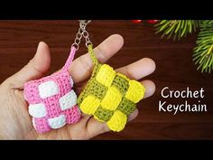 two crocheted keychains in the palm of someone's hand