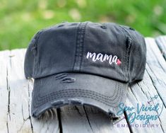 Save 20% off your first purchase by signing up at www.bit.ly/sewvividvipThis cap has Mama with a small heart at the end embroidered on your choice of cap. Cap options shown in photos. Featured Cap: 1st Photo: Black Ponytail with Pink heart2nd Photo: Dk Grey Ponytail with Aqua heart✋ Does not include back of cap embroidery. To add back of cap embroidery add this to your cart too-  https://etsy.me/2CZfOfQ🧢 Cap Details 🧢Baseball Style:Distressed 100% Cotton – Pigment DyedUnstructuredLow ProfileCl Cute Hats For Women Ball Caps, Grey Ponytail, Ball Caps For Women, Mama Hat, Football Mom Gifts, Black Ponytail, Custom Embroidered Hats, Counting Cars, Silhouette Cameo Vinyl