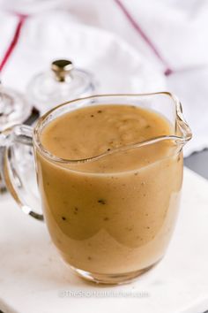 a glass pitcher filled with liquid sitting on top of a white plate