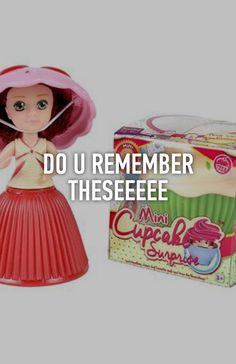 a doll with a pink hat and dress next to a box of cupcakes