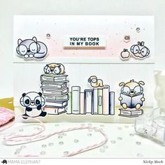 a close up of a card with animals and books