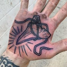 a person's hand with a tattoo on it