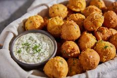 a basket filled with tater tots and dip