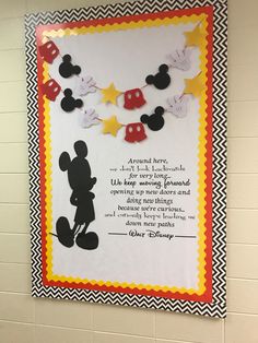 a mickey mouse bulletin board hanging on the wall