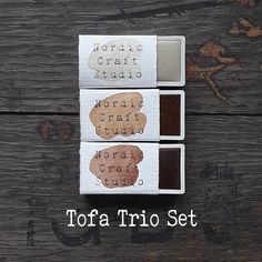 three different types of chocolate trufce sitting on top of a wooden table