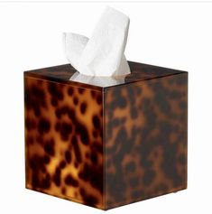 an animal print tissue dispenser box with tissue paper in it's holder